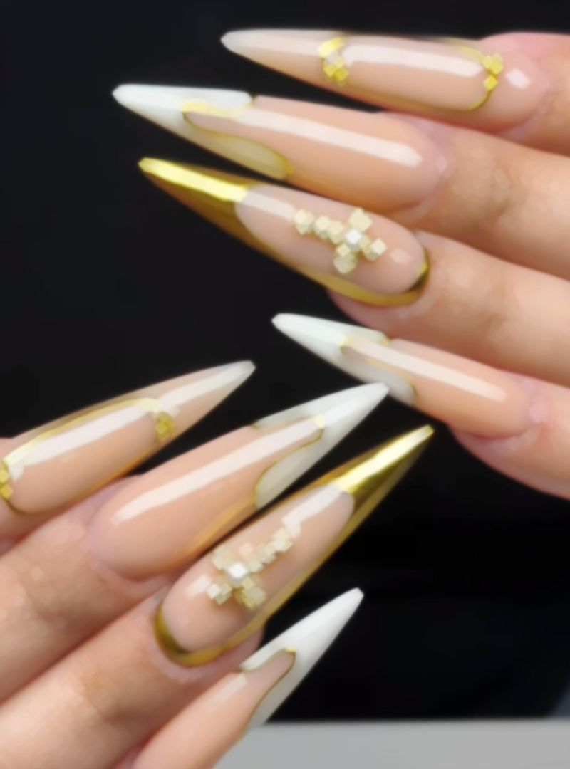 Long nude stiletto nails with white and gold chrome French tips