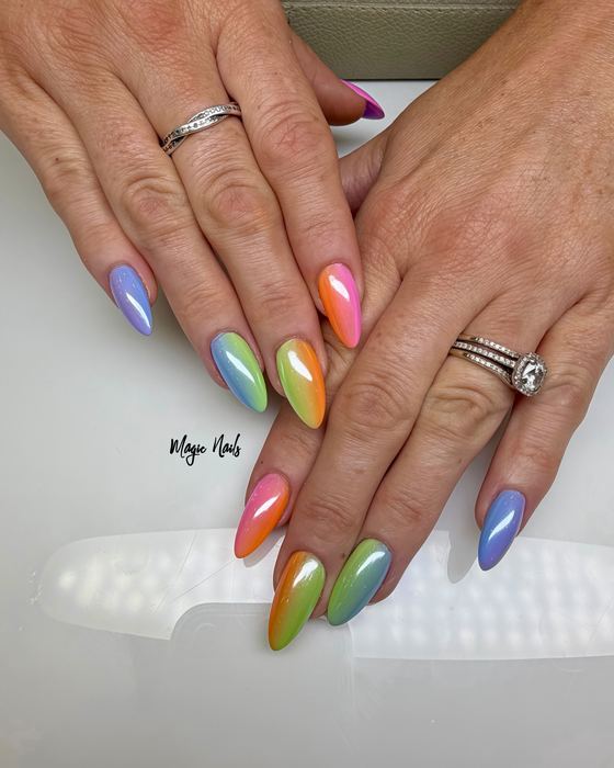 Almond nails in a rainbow chrome finish, each nail a different metallic shade